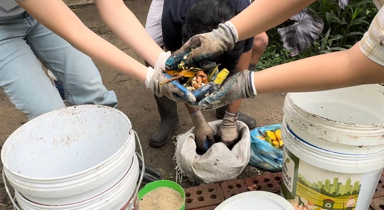 Sprout Scouts volunteers working with compost outdoors